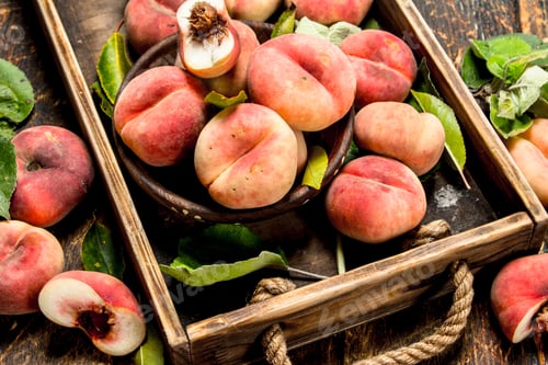 Preview: Ripe Peaches On A Tray. On A Wooden Background.