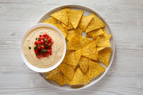 Preview: Homemade Cheesy Dip In A Bowl, Yellow Tortilla Chips, Top View. Overhead, From Above, Flat Lay.