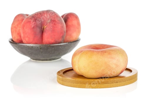 Preview: Group Of Four Whole Fresh Red Peach Prunus Persica Platycarpa In Dark Ceramic Bowl On Round Bamboo