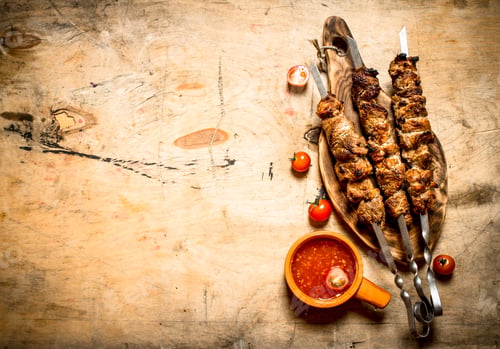 Preview: Shish Kebab With Tomato Sauce. On A Wooden Table.