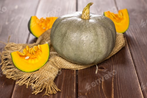 Preview: Group Of One Whole Three Slices Of Fresh Blue Grey Pumpkin Nagy Dobosi Variety On Jute Cloth On