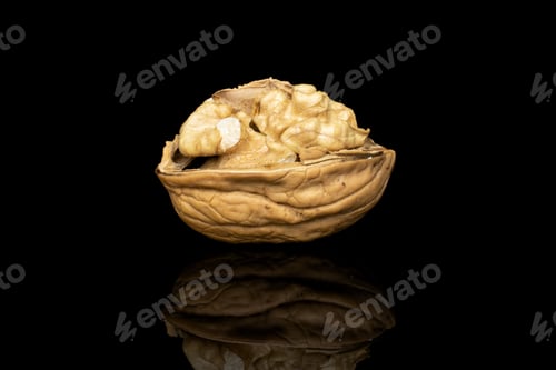 Preview: One Whole Open Tasty Brown Walnut Isolated On Black Glass