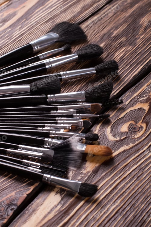 Preview: Set Of Different Brushes For Make-Up On Wooden Background.