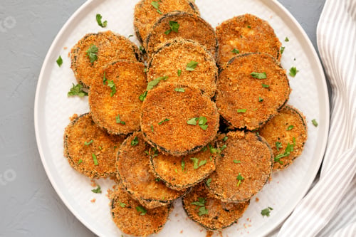 Preview: Homemade Garlic Parmesan Baked Eggplant On A Plate Over Gray Background, Top View. Flat Lay