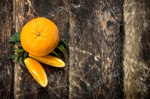 Preview: Fresh Oranges With Leaves. On A Wooden Background.