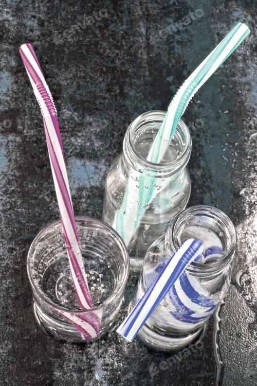 Preview: Mineral Water In Glass Bottles And Glass. Drinking Bottled Water With Cocktail Tubes On A Stylish