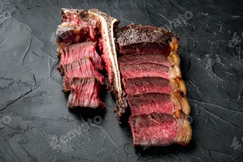 Preview: Fresh Juicy Medium Rare Sliced And Roast T Bone Or Porterhouse Beef Meat Steak Set, On Black Stone