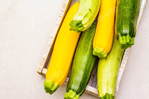 Preview: Assorted Colorful Zucchini In Wooden Box. Fresh Vegetables For Cooking. Harvest On Stone