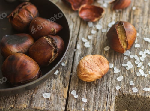 Preview: Roasted Chestnuts On Wooden Table With Coarse Salt