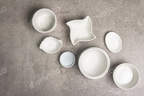 Preview: Assorted White Empty Bowls And Plates On A Stone Background. Different Ceramic Dishes And Kitchen