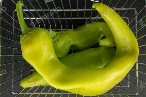 Preview: Group Of Three Whole Hot Green Pepper Banana In Shopping Basket Flatlay On Grey Stone