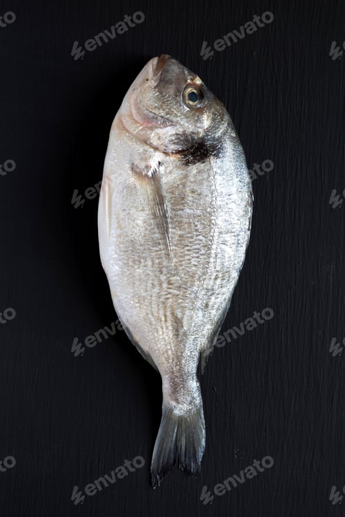 Preview: Fresh Dorado Fish Over Dark Background, Top View. Flat Lay, Overhead, From Above. Close-Up.