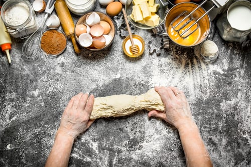Preview: Dough Background. Woman Kneads Dough With Various Ingredients On The Table. On Rustic Background .