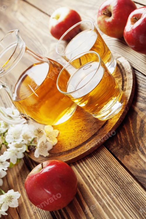 Preview: Apple Juice In The Glass Jug On The Table