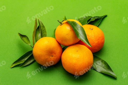 Preview: Ripe Tangerines With Leaves. Fresh Fruits Isolated On Green Background, Close Up