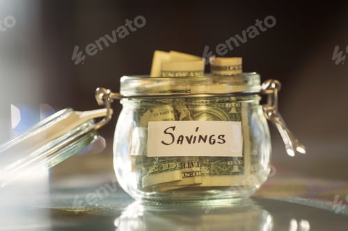 Preview: Savings Jar Full of Money on Table