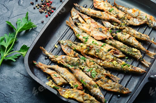 Preview: Fried Capelin Garnished With Parsley And Lemon Zest In A Pan