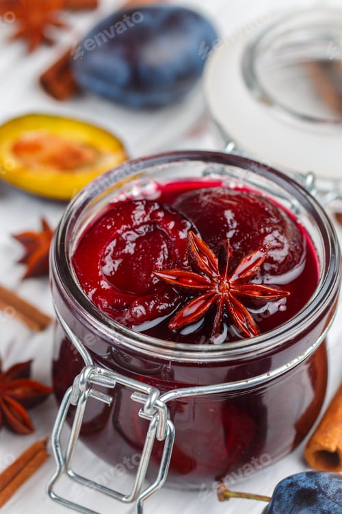 Preview: Jar With Homemade Plum Jam With Cinnamon And Star Anise On A White Wooden Background Close-Up