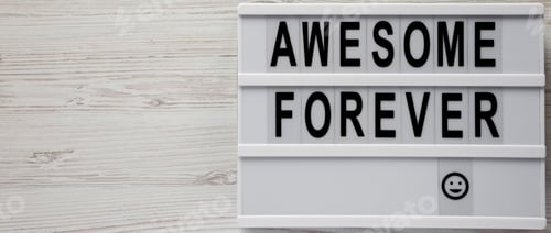 Preview: 'Awesome Forever' Word On Modern Board On A White Wooden Surface, Top View. From Above, Flat Lay