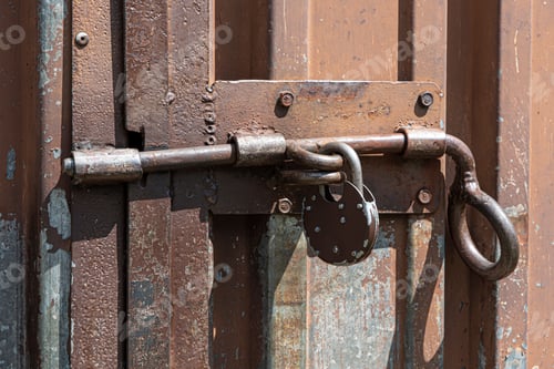 Preview: Old Rusted Grungy Metal Garage Door With Latch And Padlock. Close Up Of Rusty Vintage Lock On
