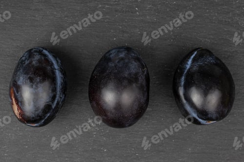 Preview: Group Of Three Whole Fresh Purple Plum Flatlay On Grey Stone