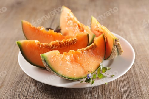 Preview: Melon Slices On Plate On Wood Background