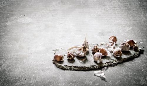 Preview: Fresh Garlic On A Stone Stand. On A Stone Background.