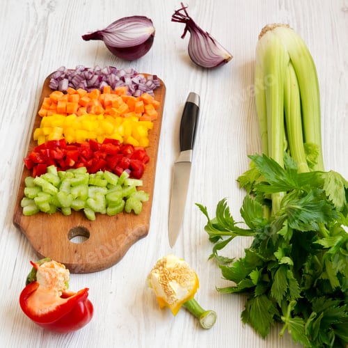 Preview: Chopped Fresh Vegetables (Carrot, Celery, Onion, Colored Peppers) Arranged On A Cutting Board On A
