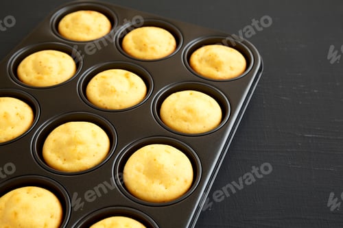 Preview: Homemade Cornbread Muffins On A Black Background, Side View. Copy Space.