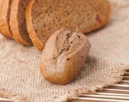 Preview: Rye Bun And Slices Of Bread On The Table
