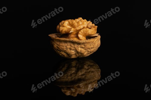 Preview: One Whole Ripe Brown Walnut Isolated On Black Glass