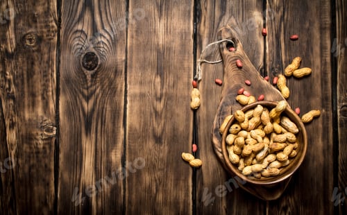 Preview: Peanuts In A Wooden Bowl . On Wooden Background.