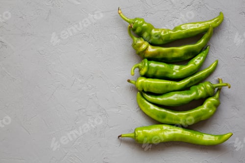 Preview: Green Chili Peppers On Gray Background. Flat Lay, From Above, Overhead. Copy Space.