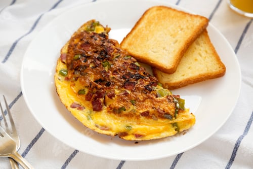 Preview: Homemade Denver Omelette On A White Plate On Cloth, Side View. Flat Lay, Top View, From Above.