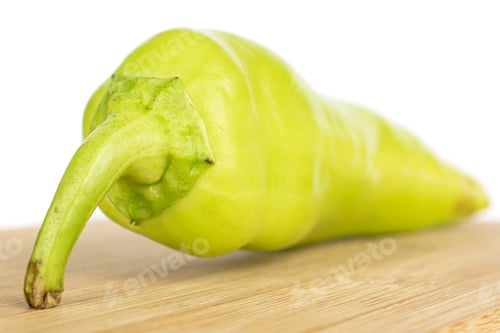 Preview: One Whole Hot Green Pepper Banana On Bamboo Cutting Board Isolated On White Background