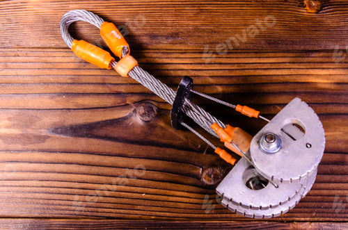 Preview: Camming Device Friend For Rock Climbing On Rustic Wooden Table. Top View