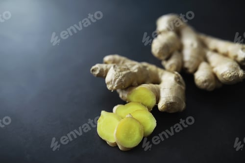 Preview: Ginger Root Whole And Sliced. Ginger Tea With Lemon On The Dark Background. Fresh Ginger Root On
