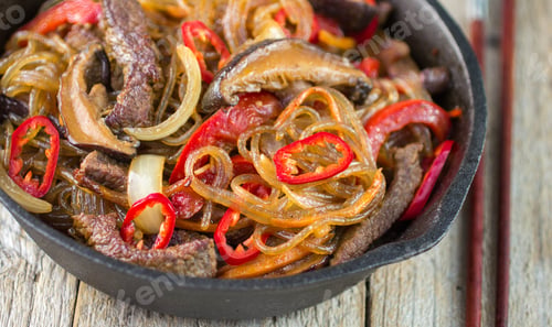 Preview: Glass Noodles With Beef, Mushrooms And Vegetables In A Cast Iron Skillet. Dish Of Korean Cuisine
