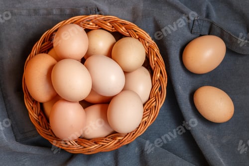 Preview: Organic Raw Brown Chicken Eggs In A Wicker Basket. Easter. Rustic Style. Soft Focus, Copy Space
