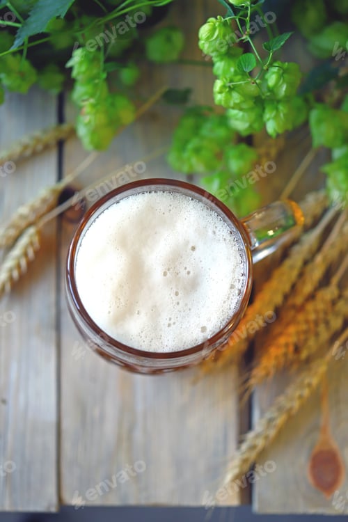 Preview: Selective Focus. A Glass Of Wheat Beer On A Wooden Surface. Wheat Ears And Hops.