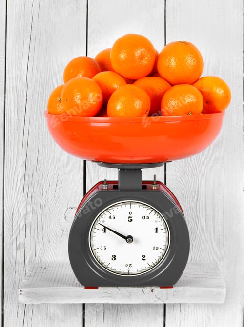 Preview: Tangerines On Scales On A Wooden Shelf.