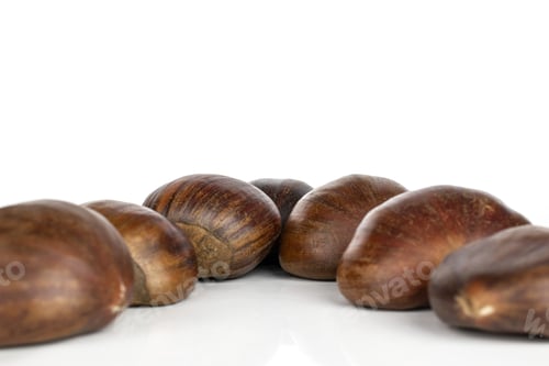 Preview: Group Of Seven Whole Edible Brown Chestnut Isolated On White Background