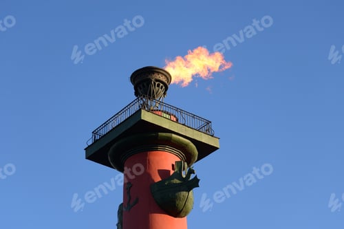 Preview: Rostral Column With A Fiery Torch On Blue Sky Background In Saint Petersburg, Russia.