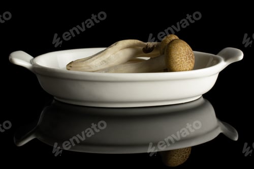 Preview: Group Of Four Whole Fresh Brown Buna Shimeji Mushroom In White Oval Ceramic Bowl Isolated On Black