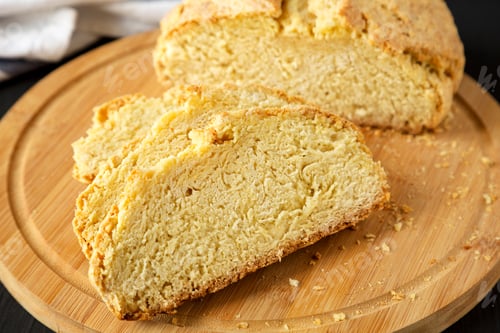 Preview: Homemade Irish Soda Bread On A Bamboo Board On A Black Surface, Low Angle View. Close-Up.