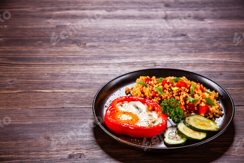 Preview: Fried Egg, Groats And Vegetables On Wooden Table