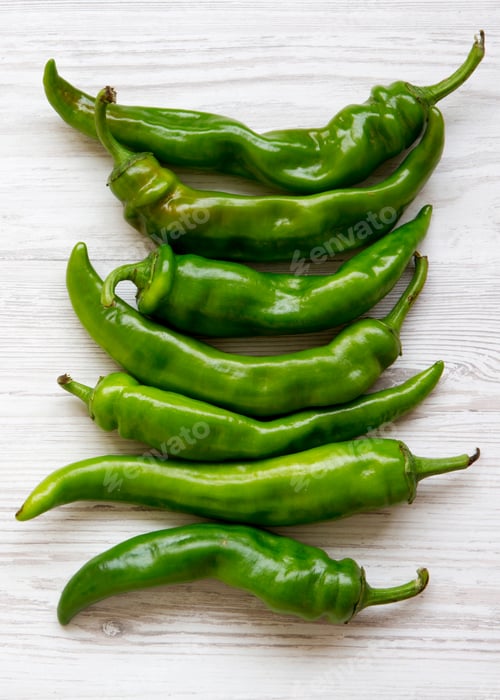 Preview: Green Chili Peppers On White Wooden Background, Top View. Flat Lay, From Above, Overhead. Copy