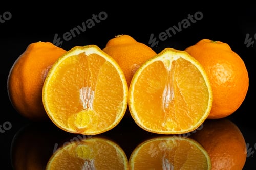 Preview: Group Of Three Whole Two Halves Of Fresh Orange Tangelo Minneola Isolated On Black Glass