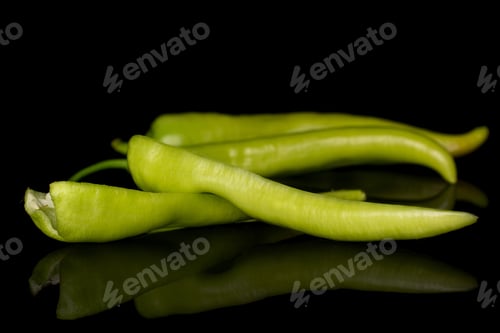 Preview: Group Of Two Whole Two Halves Of Hot Green Pepper Banana Isolated On Black Glass