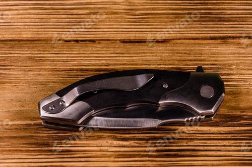 Preview: Closed Folding Knife On Rustic Wooden Table